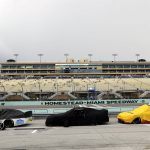 Cars are covered during a rain delay at a NASCAR Cup Series auto race Sunday, June 14, 2020, in Homestead, Fla. (AP Photo/Wilfredo Lee)