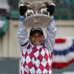 Jockey Manny Franco holds up the August Belmont trophy after riding Tiz the Law to win the 152nd running of the Belmont Stakes horse race, Saturday, June 20, 2020, in Elmont, N.Y. (AP Photo/Seth Wenig)