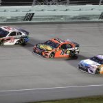 Christopher Bell (95), Martin Truex Jr. (19) and Kyle Busch (18) come through a turn during a NASCAR Cup Series auto race Sunday, June 14, 2020, in Homestead, Fla. (AP Photo/Wilfredo Lee)