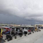 Dark clouds hang over Homestead-Miami Speedway during a weather delay at a NASCAR Cup Series auto race Sunday, June 14, 2020, in Homestead, Fla. (AP Photo/Wilfredo Lee)