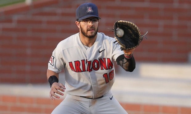 In this April 9, 2019, file photo, Arizona first baseman Austin Wells catches a throw during the te...