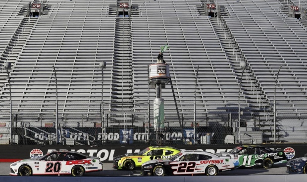 A official waves the green flag to start a NASCAR Xfinity Series auto race at Bristol Motor Speedwa...