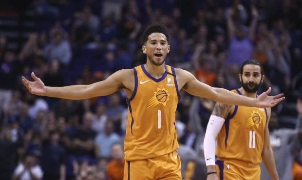 Phoenix Suns guard Devin Booker (1) celebrates a 3-pointer against the Portland Trail Blazers by Su...