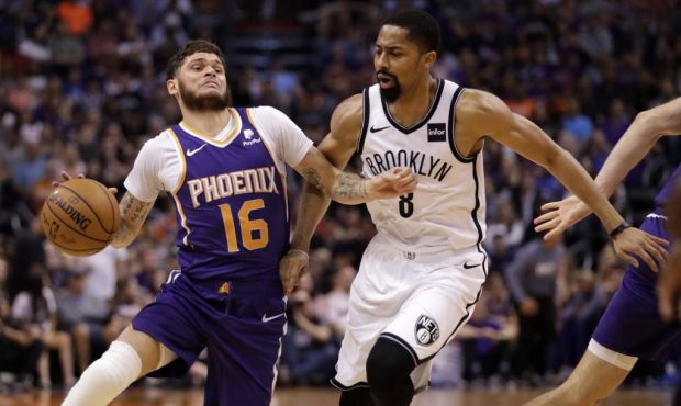 Phoenix Suns guard Tyler Johnson (16) drives past Brooklyn Nets guard Spencer Dinwiddie (8) during ...
