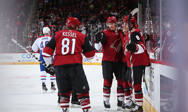 Jakob Chychrun #6 of the Arizona Coyotes celebrates with Phil Kessel #81, Clayton Keller #9 and Nic...