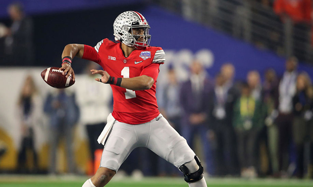 Quarterback Justin Fields #1 of the Ohio State Buckeyes throws a pass during the PlayStation Fiesta...