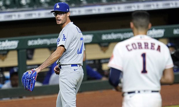 Los Angeles Dodgers relief pitcher Joe Kelly (17) looks back at Houston Astros' Carlos Correa (1) a...