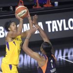 Los Angeles Sparks forward Candace Parker, left, goes up for a shot in front of Phoenix Mercury center Kia Vaughn (1) during the first half of a WNBA basketball game, Saturday, July 25, 2020, in Ellenton, Fla. (AP Photo/Phelan M. Ebenhack)