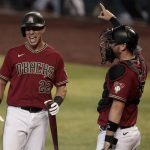 Arizona Diamondbacks' Jake Lamb (22) laughs while looking to the dugout as catcher Carson Kelly signals during an intrasquad baseball game Tuesday, July 7, 2020, in Phoenix. (AP Photo/Matt York)