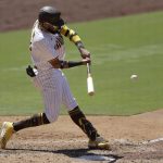 San Diego Padres' Fernando Tatis Jr. hits a three-RBI triple fourth inning of a baseball game against the Arizona Diamondbacks, Monday, July 27, 2020, in San Diego. (AP Photo/Gregory Bull)