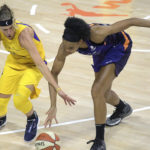 Los Angeles Sparks guard Sydney Wiese, left, and Phoenix Mercury forward Brianna Turner battle for a loose ball during the first half of a WNBA basketball game, Saturday, July 25, 2020, in Ellenton, Fla. (AP Photo/Phelan M. Ebenhack)