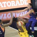 Los Angeles Sparks' Nneka Ogwumike (30) goes up for a shot between Phoenix Mercury's Kia Vaughn (1) and Diana Taurasi, right, during the first half of a WNBA basketball game, Saturday, July 25, 2020, in Ellenton, Fla. (AP Photo/Phelan M. Ebenhack)