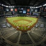 The Arizona Diamondbacks and the Los Angeles Dodgers play in an empty Chase Field during the fourth inning of the Diamondbacks' home opener baseball game Thursday, July 30, 2020, in Phoenix. (AP Photo/Ross D. Franklin)