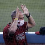 Arizona Diamondbacks manager Torey Lovullo gestures in the dugout during an exhibition baseball game against the Los Angeles Dodgers Monday, July 20, 2020, in Los Angeles. (AP Photo/Marcio Jose Sanchez)