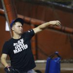 Los Angeles Dodgers' Joc Pederson wears a Black Lives Matter T-shirt as he warms up prior to an Arizona Diamondbacks' opening day baseball game Thursday, July 30, 2020, in Phoenix. (AP Photo/Ross D. Franklin)