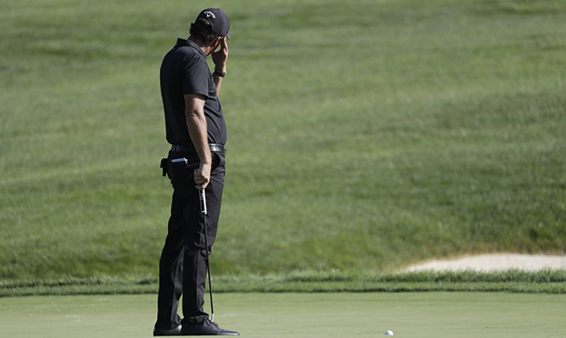 Phil Mickelson reacts to a putt on the 14th hole during the second round of the Workday Charity Ope...