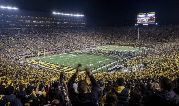 FILE - In this Oct. 13, 2018, file photo, fans cheer as the Michigan team takes the field at Michig...