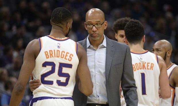 Phoenix Suns head coach Monty Williams, center talks with forward Mikal Bridges, left, during the f...