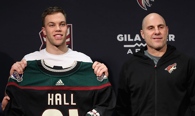Taylor Hall #91 and head coach Rich Tocchet of the Arizona Coyotes pose together during an introduc...