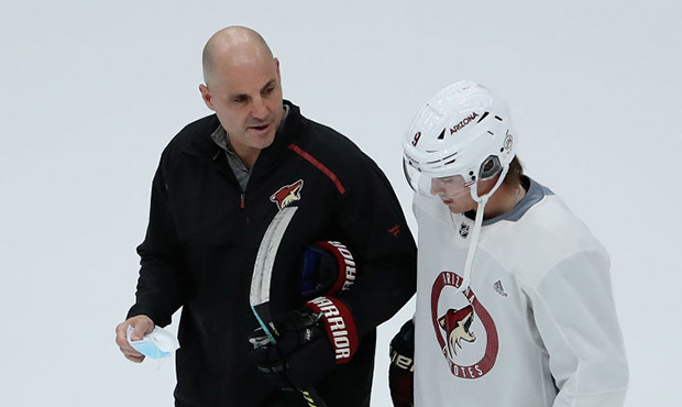 Head coach Rick Tocchet of the Arizona Coyotes talks with Clayton Keller #9 during a NHL team pract...