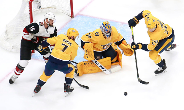Yannick Weber #7,Juuse Saros #74 and Jarred Tinordi #24 of the Nashville Predators clear the puck a...