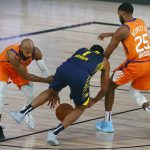 Indiana Pacers' T.J. Warren (1) and Phoenix Suns' Jevon Carter, left, and Mikal Bridges (25) fight for a loose ball during the first half of an NBA basketball game Thursday, Aug. 6, 2020, in Lake Buena Vista, Fla. (Kevin C. Cox/Pool Photo via AP)