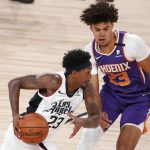 Phoenix Suns' Cameron Johnson (23)  defends Los Angeles Clippers' Lou Williams (23) during the first half of an NBA basketball game Tuesday, Aug. 4, 2020, in Lake Buena Vista, Fla. (Kevin C. Cox/Pool Photo via AP)