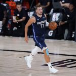 Dallas Mavericks guard Luka Doncic (77) brings the ball up court against the Phoenix Suns during the first half of an NBA basketball game Sunday, Aug. 2, 2020, in Lake Buena Vista, Fla. (AP Photo/Ashley Landis, Pool)