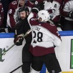 Colorado Avalanche's Ian Cole (28) roughs it up with Arizona Coyotes' Derek Stepan (21) during first-period NHL Western Conference Stanley Cup playoff hockey game action in Edmonton, Alberta, Monday, Aug. 17, 2020. (Jason Franson/The Canadian Press via AP)