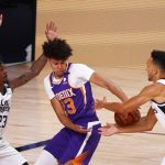 Phoenix Suns' Cameron Johnson (23) struggles to gain control of the ball between Los Angeles Clippers' Lou Williams, left,  and Landry Shamet, right during the first half of an NBA basketball game Tuesday, Aug. 4, 2020, in Lake Buena Vista, Fla. (Kevin C. Cox/Pool Photo via AP)