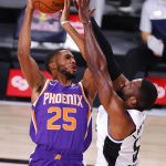 Patrick Patterson, right, of the Los Angeles Clippers, defends a shot from Mikal Bridges, left, of the Phoenix Suns during an NBA basketball game Tuesday, Aug. 4, 2020, in Lake Buena Vista, Fla. (Kevin C. Cox/Pool Photo via AP)