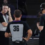 Referees confer on an out of bounds call during the second half of an NBA basketball between the Phoenix Suns and the Dallas Mavericks game Sunday, Aug. 2, 2020, in Lake Buena Vista, Fla. (AP Photo/Ashley Landis, Pool)