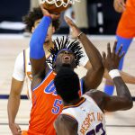 Oklahoma City Thunder's Luguentz Dort (5) goes up for a shot against Phoenix Suns' Deandre Ayton (22) during the second quarter of an NBA basketball game Monday, Aug. 10, 2020, in Lake Buena Vista, Fla. (Mike Ehrmann/Pool Photo via AP)