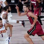 Miami Heat's Kelly Olynyk, right, reacts after scoring during the first half of an NBA basketball game against the Phoenix Suns, Saturday, Aug. 8, 2020 in Lake Buena Vista, Fla. (AP Photo/Ashley Landis, Pool)