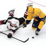 Nashville Predators' Rocco Grimaldi (23) and Arizona Coyotes' Taylor Hall (91) battle for the puck during second-period NHL hockey Stanley Cup qualifying round game action in Edmonton, Alberta, Sunday, Aug. 2, 2020. (Jason Franson/The Canadian Press via AP)