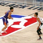Los Angeles Clippers' Landry Shamet, right, defends Phoenix Suns' Devin Booker during an NBA basketball game Tuesday, Aug. 4, 2020, in Lake Buena Vista, Fla. (Kevin C. Cox/Pool Photo via AP)