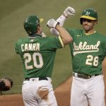 Oakland Athletics' Matt Olson, right, celebrates with Mark Canha (20) after hitting a two-run home run off Arizona Diamondbacks pitcher Alex Young in the fourth inning of a baseball game Thursday, Aug. 20, 2020, in Oakland, Calif. (AP Photo/Ben Margot)