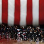 Members of the Los Angeles Clippers kneel for the national anthem before their NBA basketball game against the Phoenix Suns Tuesday, Aug. 4, 2020, in Lake Buena Vista, Fla. (Kevin C. Cox/Pool Photo via AP)