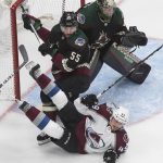 Colorado Avalanche's Samuel Girard (49) is checked by Arizona Coyotes' Jason Demers (55) as goalie Darcy Kuemper (35) looks for the shot during the first period in Game 4 of an NHL hockey first-round playoff series in Edmonton, Alberta, Monday, Aug. 17, 2020. (Jason Franson/The Canadian Press via AP)