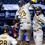 San Diego Padres' Eric Hosmer celebrates with Fernando Tatis Jr. (23) and Tommy Pham (28) after hitting a two-run home run against the Arizona Diamondbacks in the sixth inning during a baseball game, Sunday, Aug 16, 2020, in Phoenix. (AP Photo/Rick Scuteri)