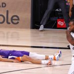 Phoenix Suns' Devin Booker falls to the ground after scoring the game-winning basket against the Los Angeles Clippers in an NBA basketball game Tuesday, Aug. 4, 2020, in Lake Buena Vista, Fla. (Kevin C. Cox/Pool Photo via AP)