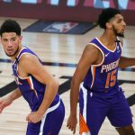 Phoenix Suns' Devin Booker (1) and Cameron Payne (15) look on during an NBA basketball game against the Los Angeles Clippers Tuesday, Aug. 4, 2020, in Lake Buena Vista, Fla. (Kevin C. Cox/Pool Photo via AP)