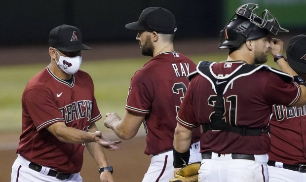 Arizona Diamondbacks starting pitcher Robbie Ray is pulled from the game by manager Torey Lovullo, ...