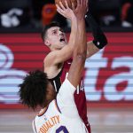 Miami Heat's Tyler Herro, right, shoots as Phoenix Suns' Cameron Johnson (23) defends during the first half of an NBA basketball game, Saturday, Aug. 8, 2020 in Lake Buena Vista, Fla. (AP Photo/Ashley Landis, Pool)