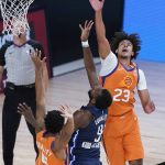 Phoenix Suns' Cameron Johnson (23) knocks the ball away from Dallas Mavericks' Michael Kidd-Gilchrist (9) during the second half of an NBA basketball game Thursday, Aug. 13, 2020 in Lake Buena Vista, Fla. (AP Photo/Ashley Landis, Pool)