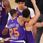 Phoenix Suns' Devin Booker celebrates with teammates after scoring the game winning basket against the Los Angeles Clippers during an NBA basketball game Tuesday, Aug. 4, 2020, in Lake Buena Vista, Fla. (Kevin C. Cox/Pool Photo via AP)