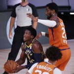 Indiana Pacers' Victor Oladipo (4) drives to the basket as Phoenix Suns' Deandre Ayton (22) defends during the first half of an NBA basketball game Thursday, Aug. 6, 2020, in Lake Buena Vista, Fla. (Kevin C. Cox/Pool Photo via AP)