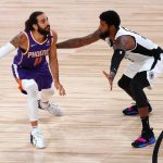 Phoenix Suns' Ricky Rubio (11) looks for a pass around Los Angeles Clippers' Paul George during an NBA basketball game Tuesday, Aug. 4, 2020, in Lake Buena Vista, Fla. (Kevin C. Cox/Pool Photo via AP)