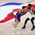 Los Angeles Clippers' Paul George defends against Phoenix Suns' Devin Booker (1) during an NBA basketball game Tuesday, Aug. 4, 2020, in Lake Buena Vista, Fla. (Kevin C. Cox/Pool Photo via AP)