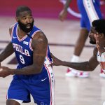 Philadelphia 76ers center Kyle O'Quinn (9) looks for help as Phoenix Suns center Deandre Ayton, right, defends during the first half of an NBA basketball game Tuesday, Aug. 11, 2020, in Lake Buena Vista, Fla. (AP Photo/Ashley Landis, Pool)